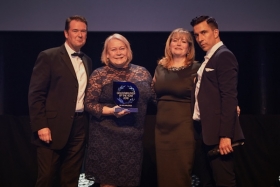 Susan Peary, managing director and Helen Lupton, compliance director receiving their award, from comedian Russell Kane, at the IIP Awards Ceremony