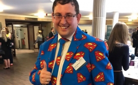 Conference Co-chair Dan Atkinson in his Superman business suit for the Superhero-themed CISI / IFP Paraplanning Conference